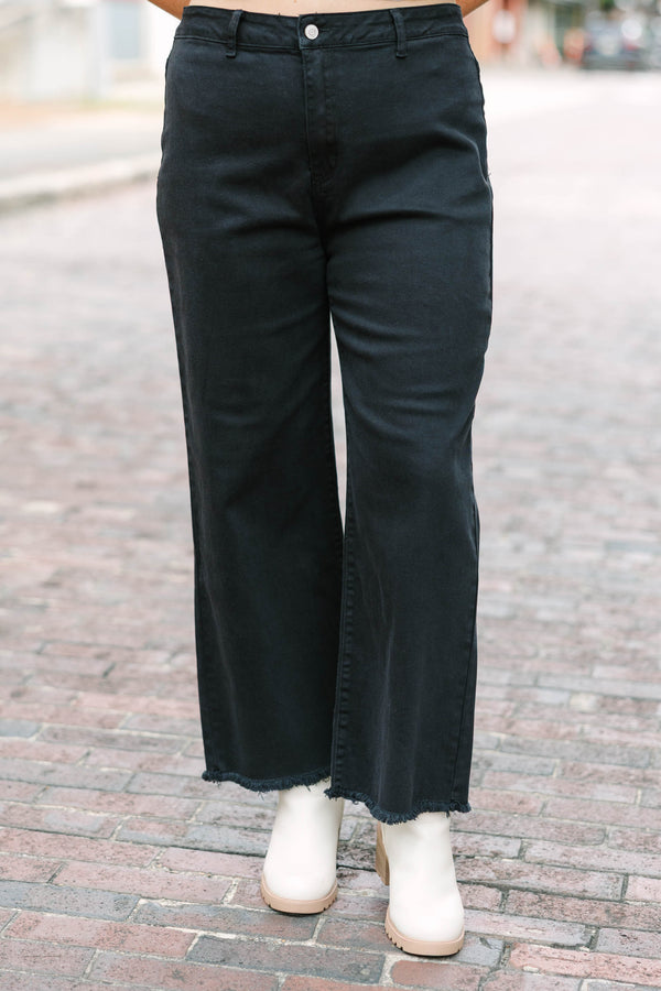 Plus Size black acid-washed wide-leg jeans with a frayed cutoff hem and a straight fit.