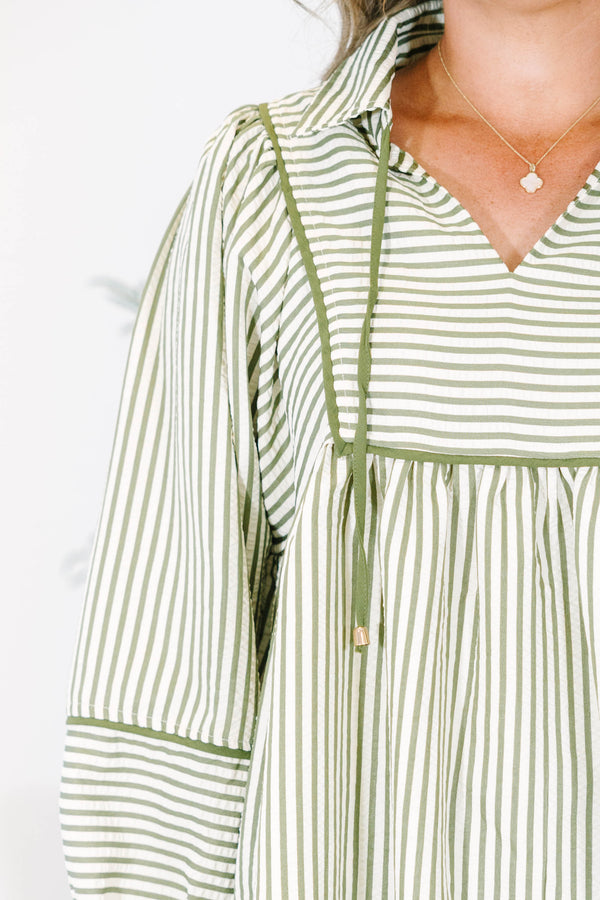 Plus size olive and white striped flowy top with long puff sleeves and a v-neckline.