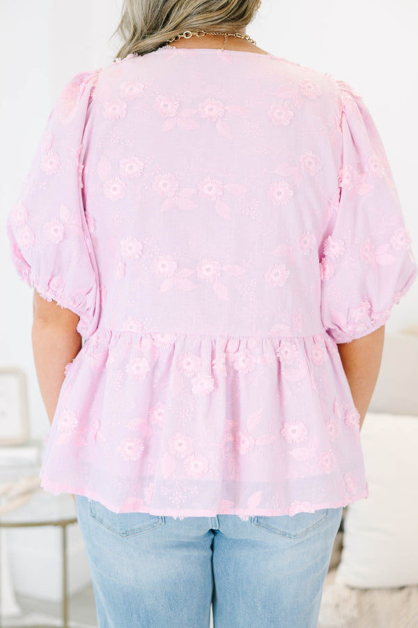 Plus Size pink eyelet top with puff sleeves, three front bow ties, and a peplum hem.