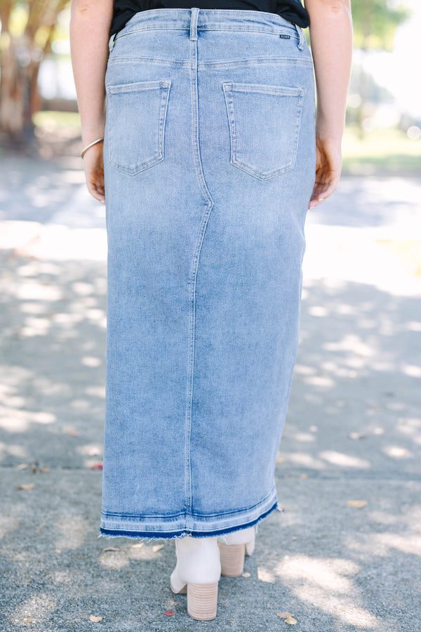 Plus size medium wash denim midi skirt with a front slit and raw hem for a confident, chic look.