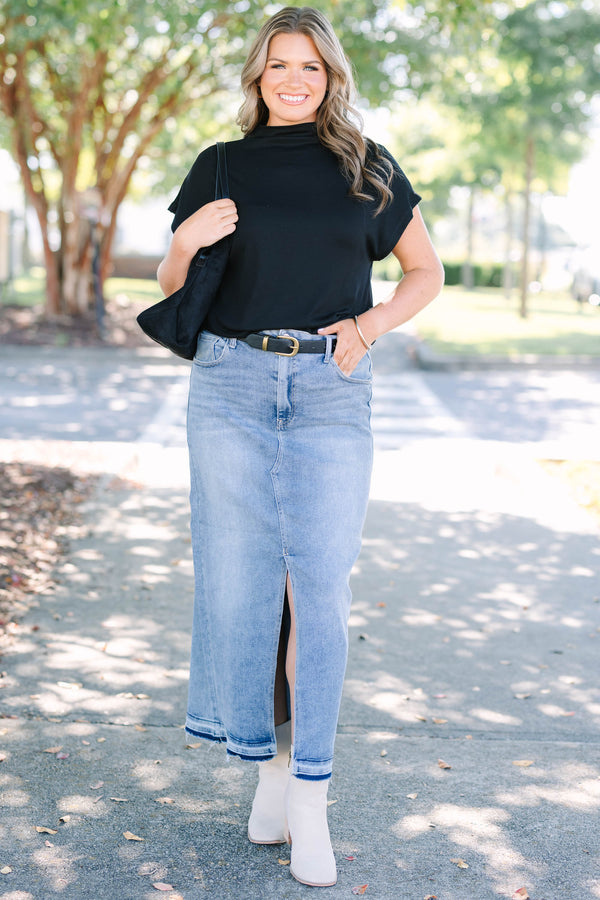 Plus size medium wash denim midi skirt with a front slit and raw hem for a confident, chic look.
