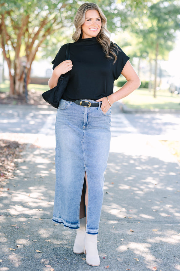 Plus size medium wash denim midi skirt with a front slit and raw hem for a confident, chic look.
