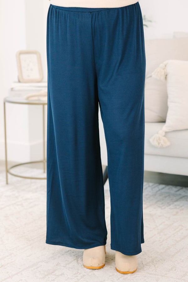 Plus size navy flowy palazzo pants with a high-rise elastic waistband in a soft ribbed fabric.