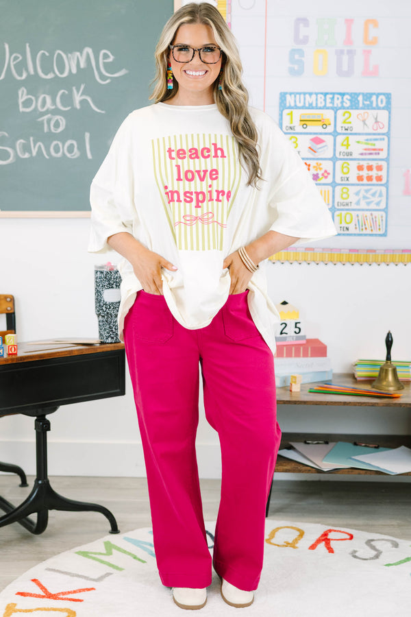 Plus Size ivory boyfriend tee with 'teach love inspire' graphic and pink pants.