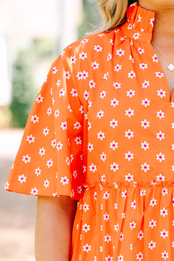 Plus size red floral mini dress with a flowy tiered silhouette and short ruffle sleeves.