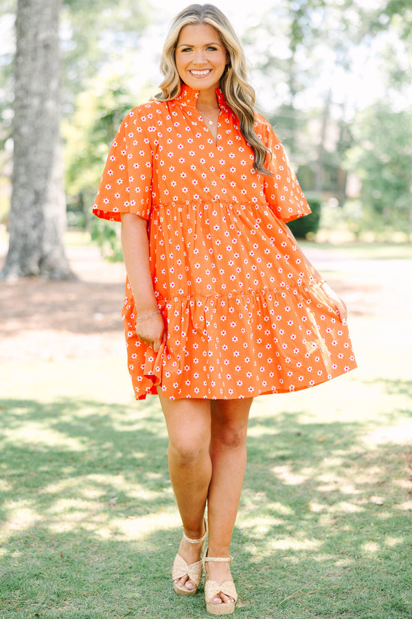 Plus size red floral mini dress with a flowy tiered silhouette and short ruffle sleeves.