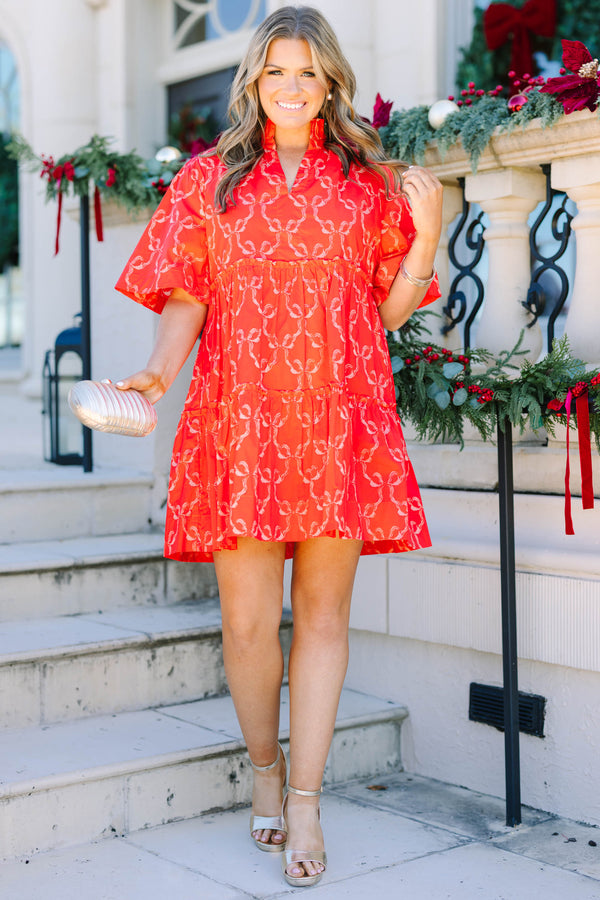 Plus size red bow print mini dress with a flowy tiered silhouette and short flutter sleeves.