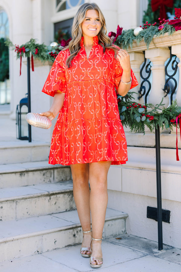 Plus size red bow print mini dress with a flowy tiered silhouette and short flutter sleeves.
