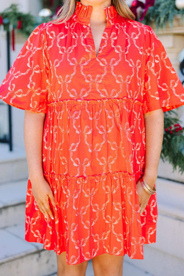 Plus size red bow print mini dress with a flowy tiered silhouette and short flutter sleeves.
