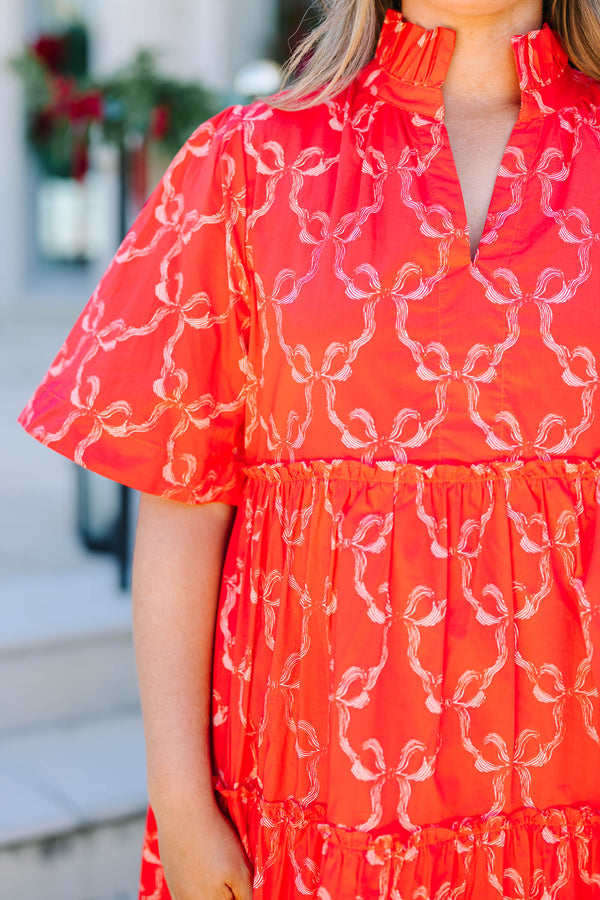 Plus size red bow print mini dress with a flowy tiered silhouette and short flutter sleeves.