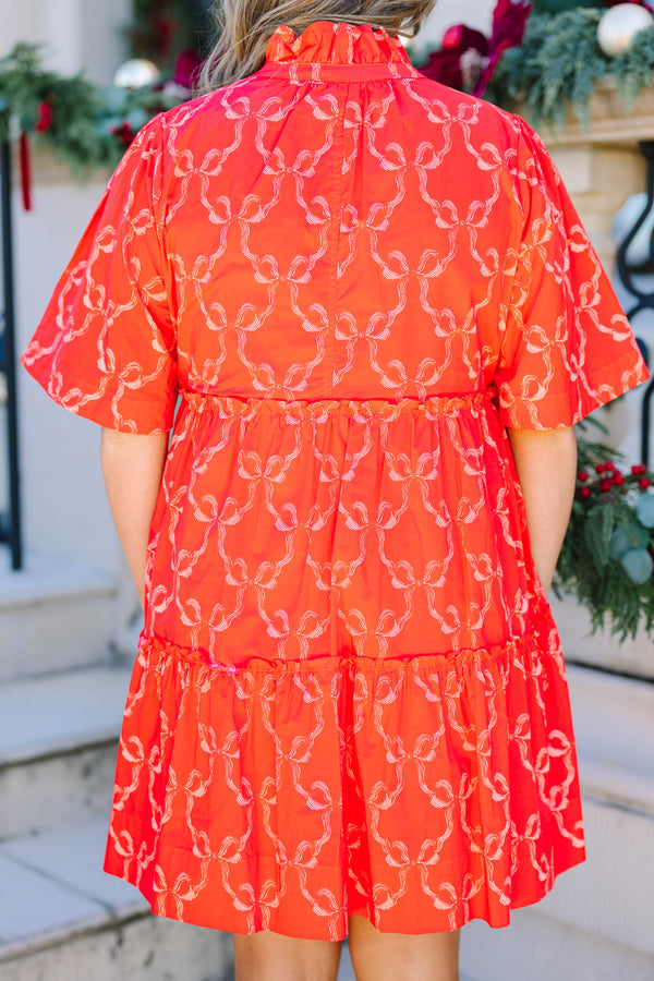 Plus size red bow print mini dress with a flowy tiered silhouette and short flutter sleeves.