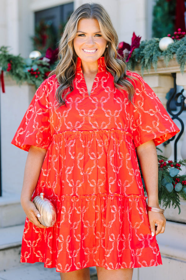 Plus size red bow print mini dress with a flowy tiered silhouette and short flutter sleeves.