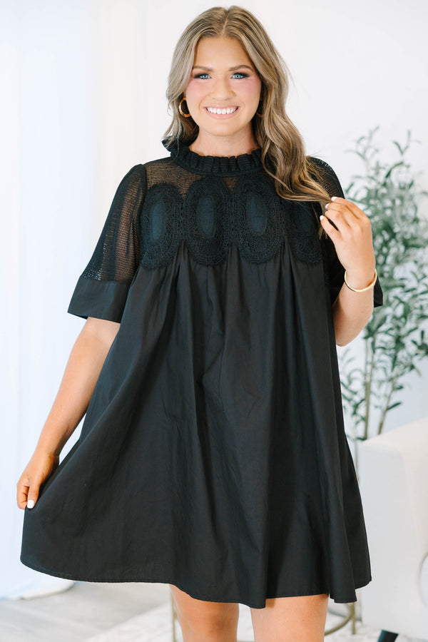 Plus size black cotton mini dress with a flowy fit, mesh yoke, and intricate lace detailing.