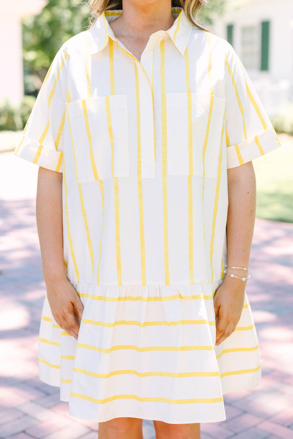 Plus Size yellow and white striped short sleeve shirt dress with a collared neckline and tiered hem.