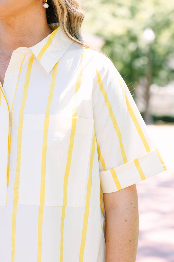 Plus Size yellow and white striped short sleeve shirt dress with a collared neckline and tiered hem.