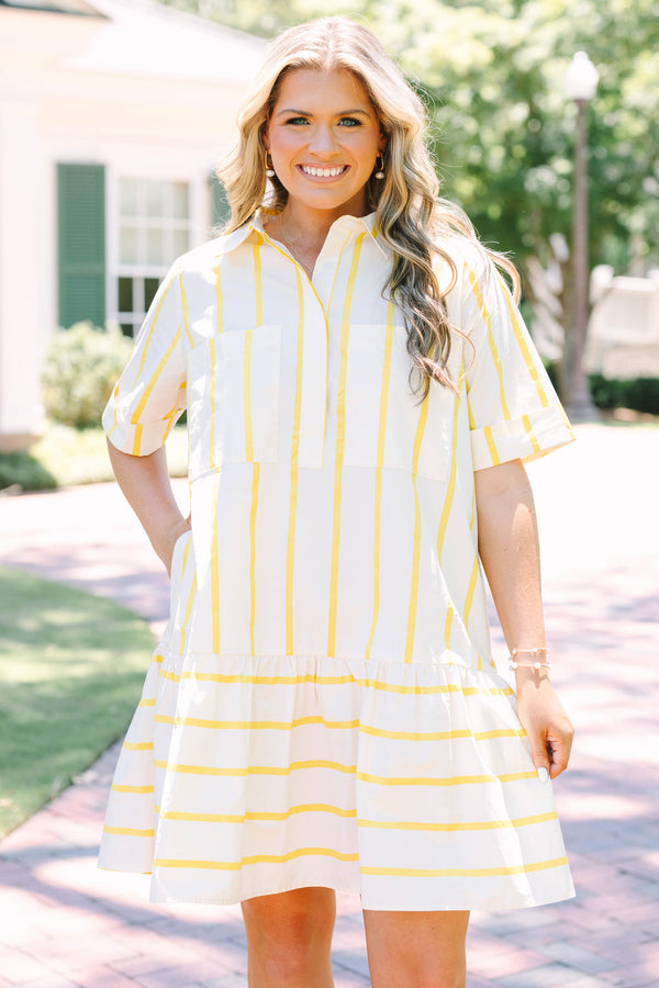 Plus Size yellow and white striped short sleeve shirt dress with a collared neckline and tiered hem.