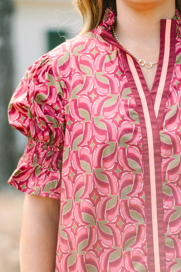 Plus Size wine-colored cotton top with a geometric pattern, V-neckline, and puffed short sleeves.