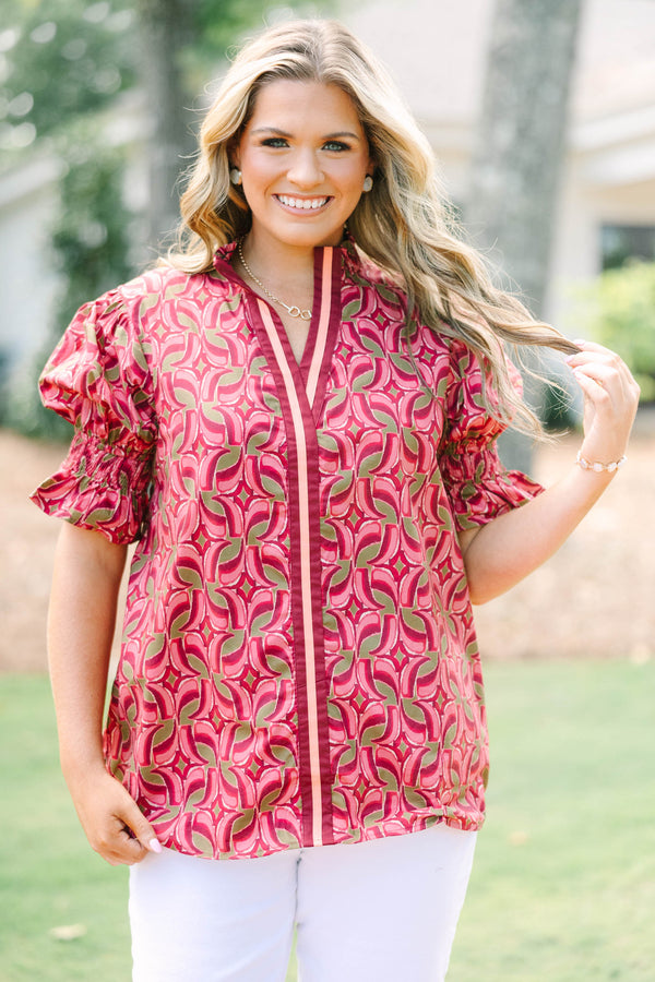 Plus Size wine-colored cotton top with a geometric pattern, V-neckline, and puffed short sleeves.