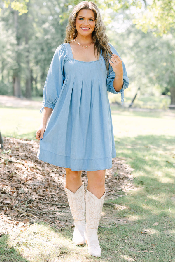 Plus Size light blue denim-look dress with a square neckline, pleated bodice, and puff sleeves.