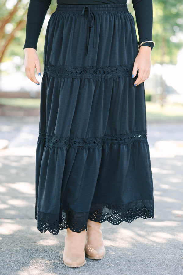 Plus size black tiered maxi skirt with lace trim, smocked waist, and flowy silhouette.