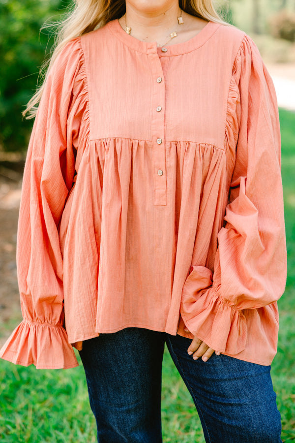 Chic Soul plus size clothing, salmon pink long sleeve button up top with ruffles on the end of the sleeves
