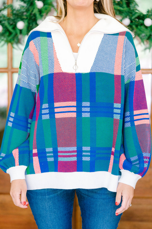 Chic Soul plus size clothing, blue multi colored sweater with a plaid pattern and white detailing on the end of the sleeves and the bottom of the sweater as well as a zipper on the chest  