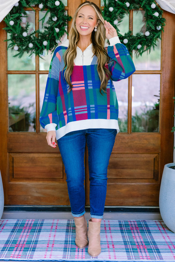 Chic Soul plus size clothing, blue multi colored sweater with a plaid pattern and white detailing on the end of the sleeves and the bottom of the sweater as well as a zipper on the chest  