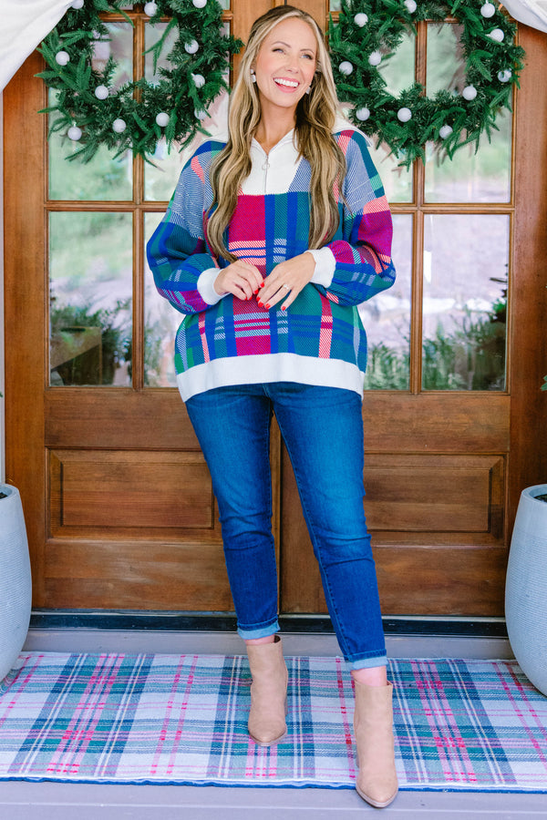 Chic Soul plus size clothing, blue multi colored sweater with a plaid pattern and white detailing on the end of the sleeves and the bottom of the sweater as well as a zipper on the chest  