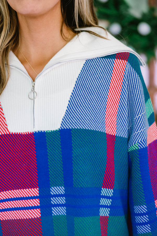 Chic Soul plus size clothing, blue multi colored sweater with a plaid pattern and white detailing on the end of the sleeves and the bottom of the sweater as well as a zipper on the chest  