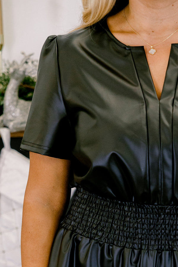 Chic Soul plus size clothing, black short sleeve faux leather mini dress with cinched smocked waist with v cutout along neckline with ruffle along bottom
