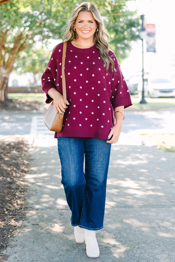 Plus size burgundy polka dot sweater with a relaxed fit, crew neck, and soft knit fabric.