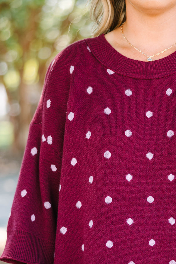 Plus size burgundy polka dot sweater with a relaxed fit, crew neck, and soft knit fabric.