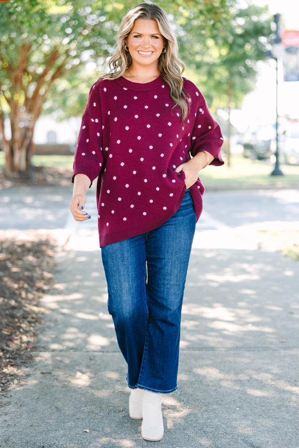 Plus size burgundy polka dot sweater with a relaxed fit, crew neck, and soft knit fabric.