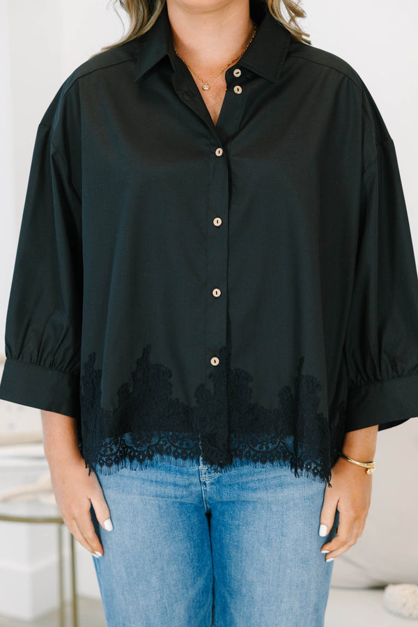 Plus size black button-down top with a flowy fit and delicate lace hem detail.