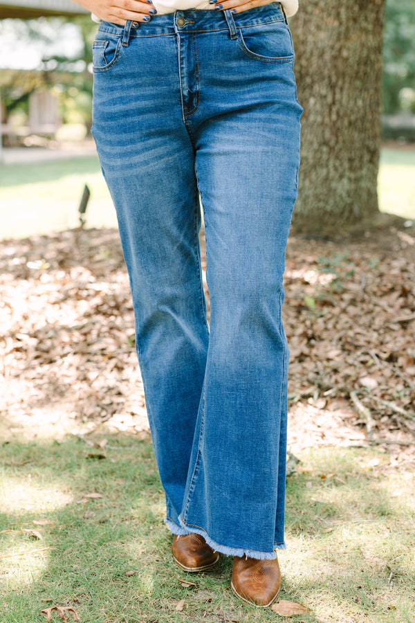 Plus size medium wash flare jeans with a raw hem and stretchy denim for a confident, flowy fit.