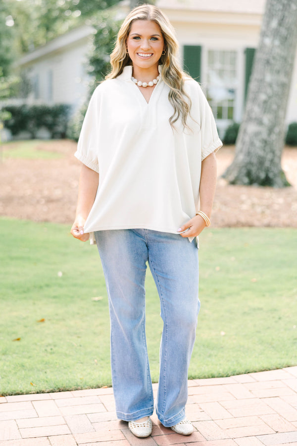 Plus Size beige short sleeve top with a V-neckline and elasticized puff sleeves.