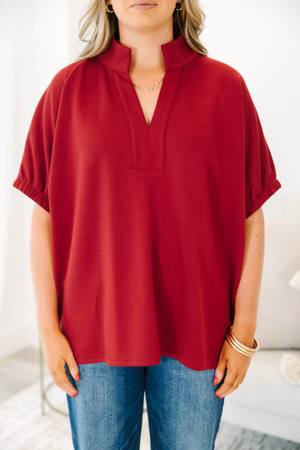 Plus Size cabernet red top with a v-neckline, relaxed fit, and short elasticized sleeves.