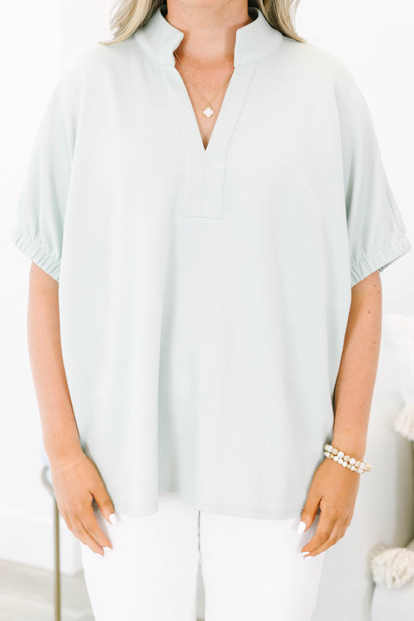 Plus Size sage green short sleeve top with a split neckline and elasticized puff sleeves.