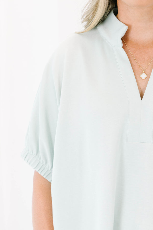 Plus Size sage green short sleeve top with a split neckline and elasticized puff sleeves.