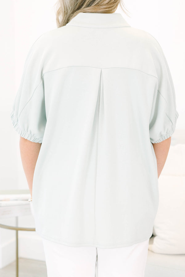 Plus Size sage green short sleeve top with a split neckline and elasticized puff sleeves.