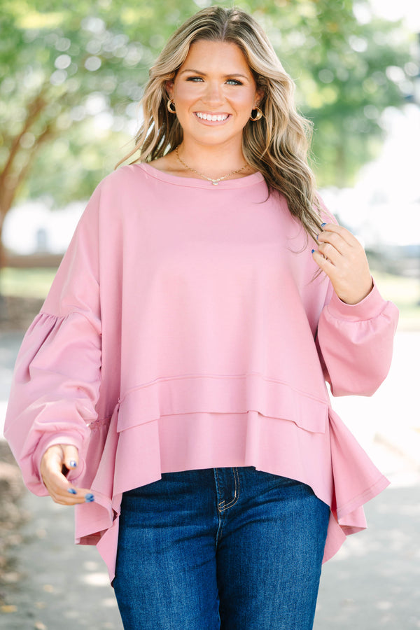 Plus size pink cotton top with a flowy tiered ruffle hem and voluminous puff sleeves.