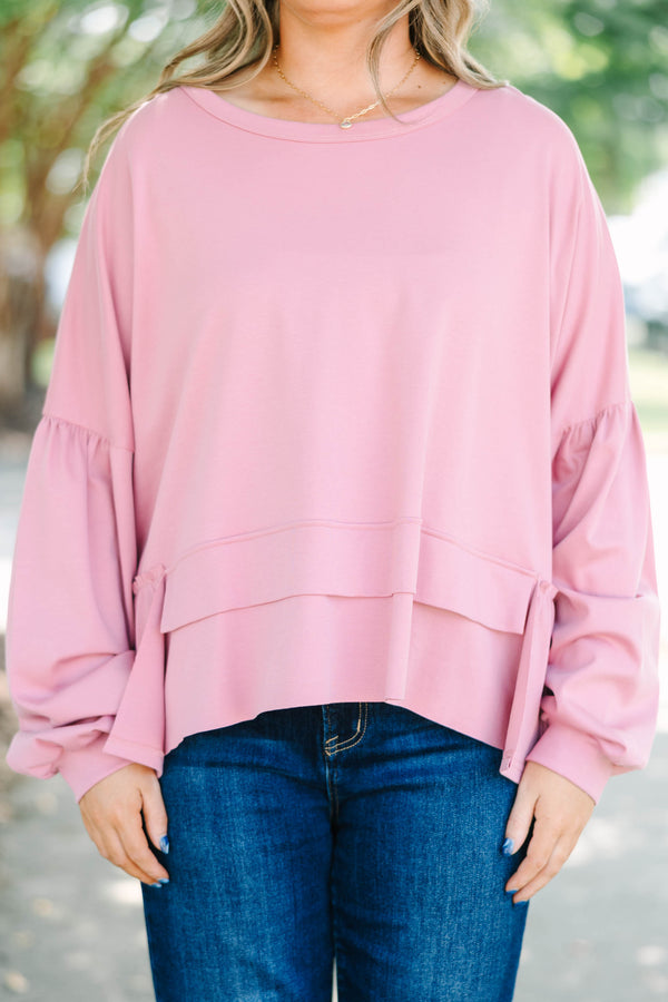 Plus size pink cotton top with a flowy tiered ruffle hem and voluminous puff sleeves.