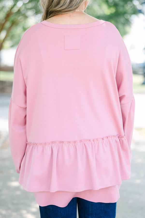 Plus size pink cotton top with a flowy tiered ruffle hem and voluminous puff sleeves.