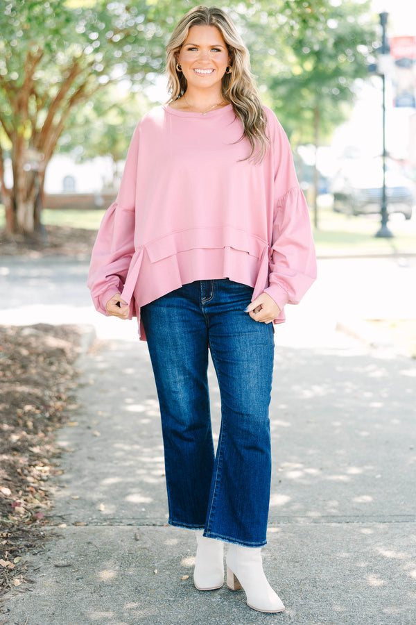 Plus size pink cotton top with a flowy tiered ruffle hem and voluminous puff sleeves.