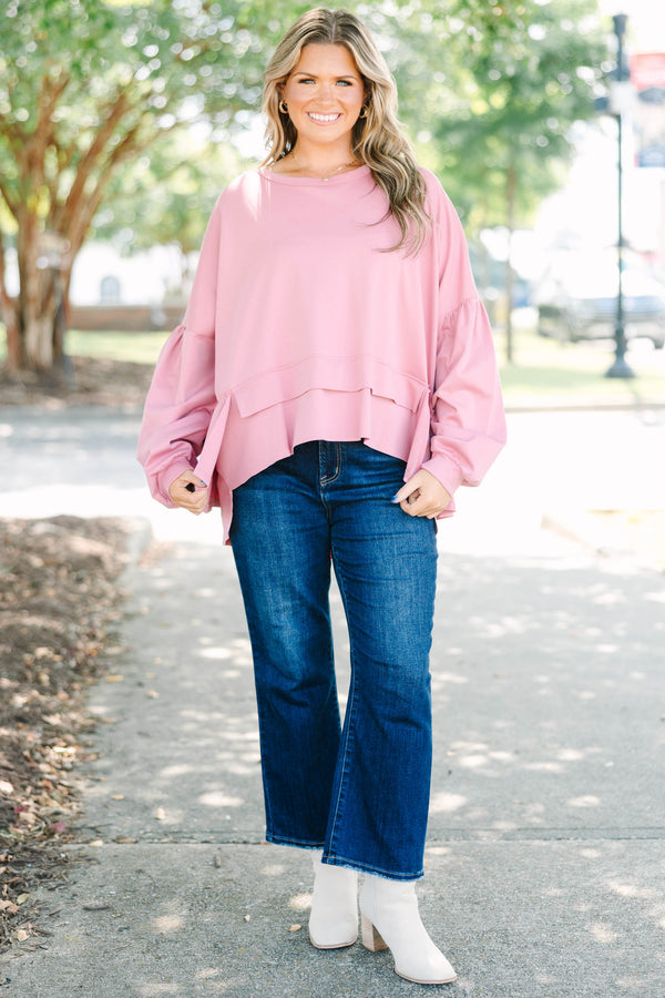 Plus size pink cotton top with a flowy tiered ruffle hem and voluminous puff sleeves.