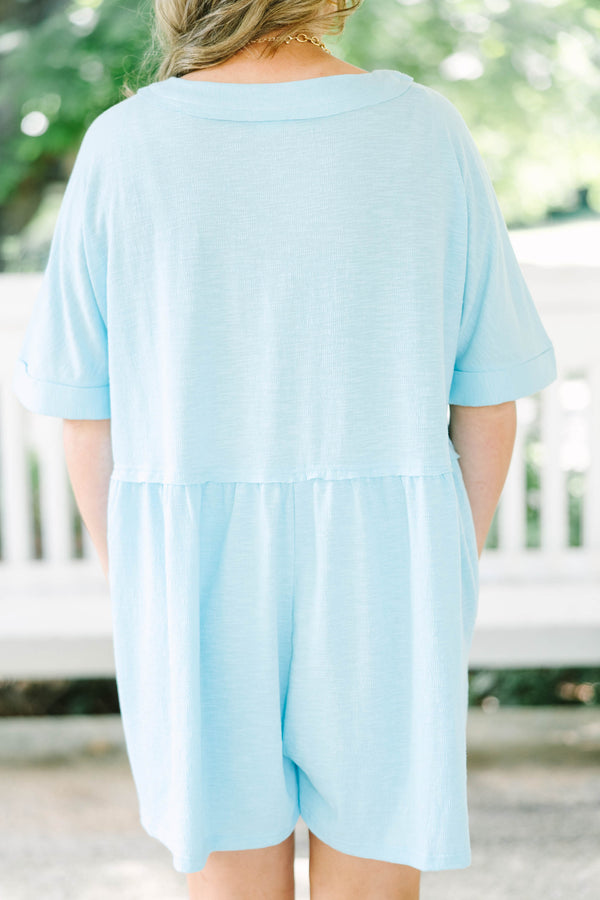 Plus Size aqua romper with a V-neckline, functional front buttons, short sleeves, and side pockets.