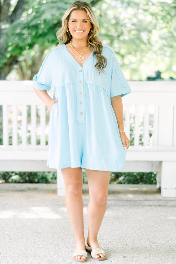 Plus Size aqua romper with a V-neckline, functional front buttons, short sleeves, and side pockets.