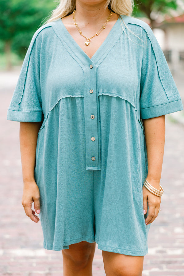 Chic Soul plus size clothing, dusty teal romper with short sleeves that have cuffs at the end of the sleeves and buttons going down to the waist area 