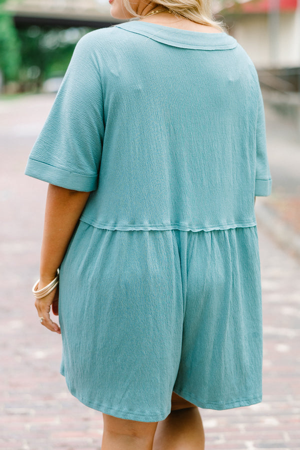 Chic Soul plus size clothing, dusty teal romper with short sleeves that have cuffs at the end of the sleeves and buttons going down to the waist area 