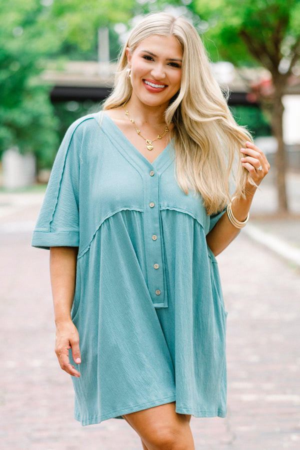 Chic Soul plus size clothing, dusty teal romper with short sleeves that have cuffs at the end of the sleeves and buttons going down to the waist area 